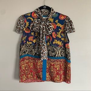 Alice + Olivia multi-patterned, short-sleeved blouse.